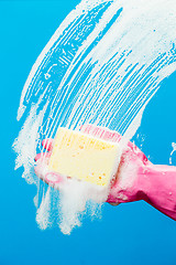 Image showing Man washes glass with sponge