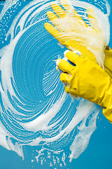 Image showing Window cleaner in rubber gloves washes