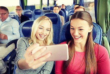 Image showing women taking selfie by smartphone in travel bus