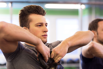 Image showing close up of man with kettlebell exercising in gym