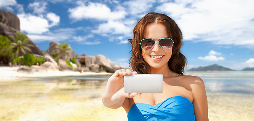 Image showing woman in swimsuit taking selfie with smatphone