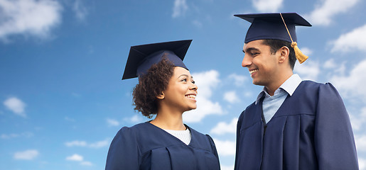 Image showing happy students or bachelors in mortar boards