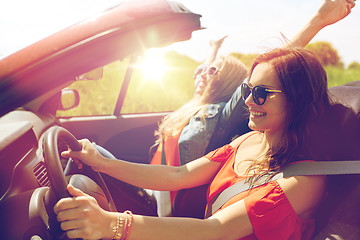 Image showing smiling young women driving in cabriolet car