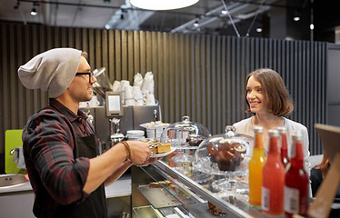 Image showing man or barman with cake serving customer at cafe