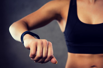 Image showing woman with heart-rate watch in gym