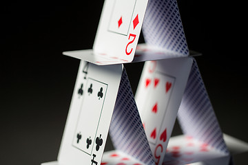 Image showing close up of house of playing cards over black