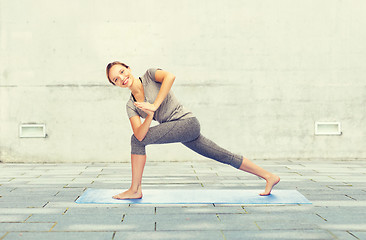 Image showing woman making yoga low angle lunge pose on mat