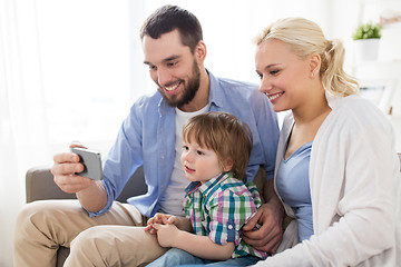 Image showing happy family with smartphone at home