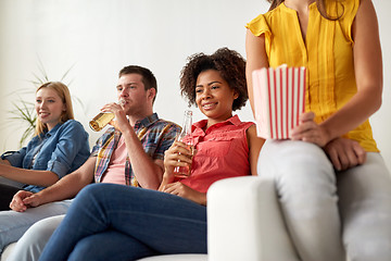 Image showing happy friends with popcorn watching tv at home