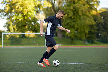 Image showing soccer player playing with ball on football field