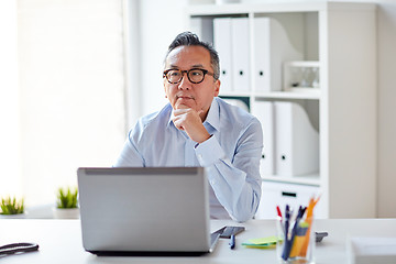 Image showing businessman in eyeglasses with laptop office