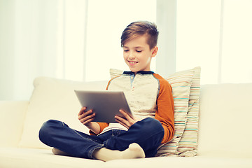 Image showing smiling boy with tablet computer at home