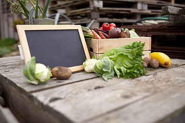 Image showing close up of vegetables with chalkboard on farm