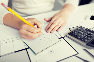 Image showing close up of architect hand writing to notebook