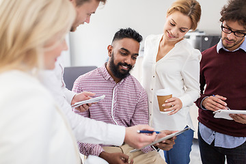 Image showing business team with tablet pc and coffee at office