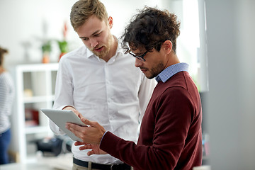 Image showing close up of business team with tablet pc at office