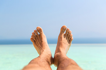 Image showing male feet on beach