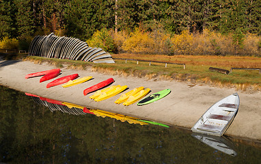 Image showing Stacks of Rental Boats Canoes Wait on the Beach