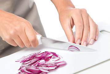 Image showing Cook is chopping onion