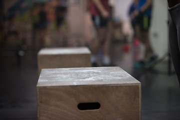 Image showing black woman is performing box jumps at gym