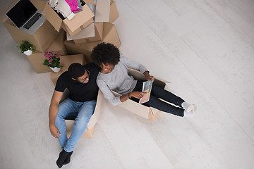 Image showing African American couple  playing with packing material