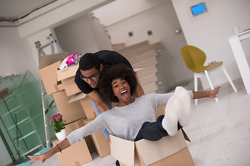 Image showing African American couple  playing with packing material