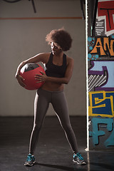 Image showing black woman carrying crossfit ball