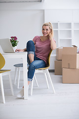 Image showing Young woman moving in a new home