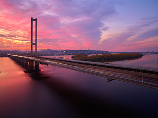 Image showing Automobile and railroad bridge in Kiev, the capital of Ukraine. Bridge at sunset across the Dnieper River. Kiev bridge against the backdrop of a beautiful sunset in Kiev. Bridge in evening sunshine