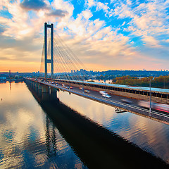 Image showing Automobile and railroad bridge in Kiev, the capital of Ukraine. Bridge at sunset across the Dnieper River. Kiev bridge against the backdrop of a beautiful sunset in Kiev. Bridge in evening sunshine