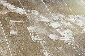 Image showing Foot prints on the tiled floor