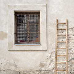 Image showing abandoned cracked brick wall with a window