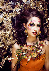 Image showing beauty woman with face art and jewelry from flowers orchids clos