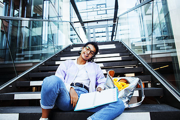 Image showing young cute indian girl at university building sitting on stairs 