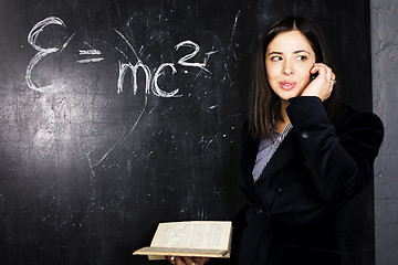 Image showing portrait of happy cute student in classroom at blackboard back t