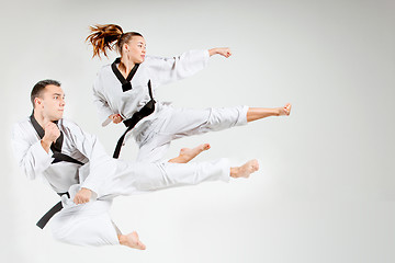 Image showing The karate girl and man with black belts