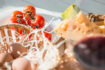 Image showing Wine, baguette and cheese on wooden background