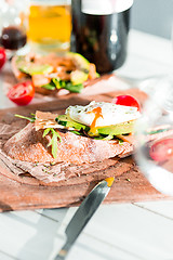 Image showing Wine, baguette and cheese on wooden background