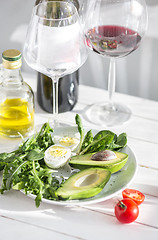 Image showing Wine, Tomatoes and greenery wooden background