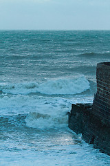 Image showing Rough Sea and Jetty at Dusk