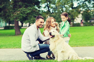 Image showing happy family with labrador retriever dog in park