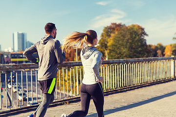 Image showing happy couple running outdoors