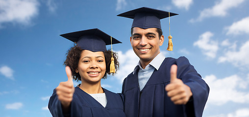 Image showing happy students or bachelors showing thumbs up