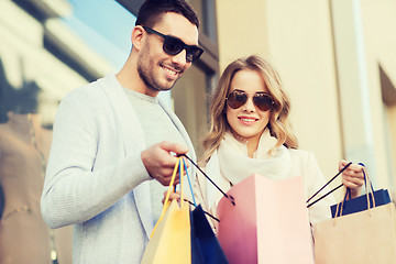 Image showing happy couple with shopping bags on city street