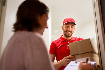 Image showing deliveryman and customer with parcel boxes at home