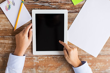 Image showing close up of female hands with tablet pc on table