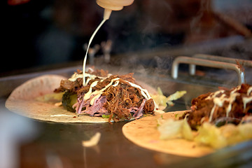 Image showing tortilla wraps cooking at street market