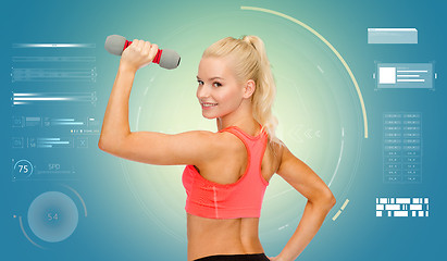 Image showing happy young sporty woman exercising with dumbbells