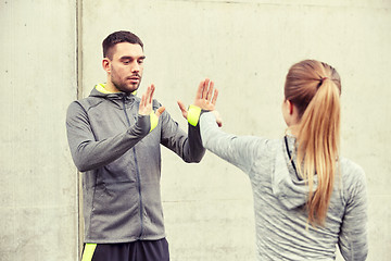 Image showing woman with trainer working out self defense strike