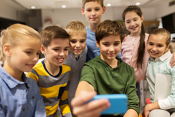 Image showing group of school kids taking selfie with smartphone